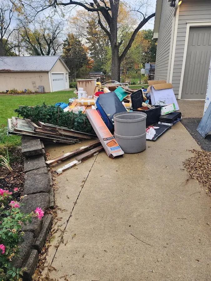 Dumpster being loaded with debris for Estate Cleanout Dumpster Rental in Chesapeake Beach